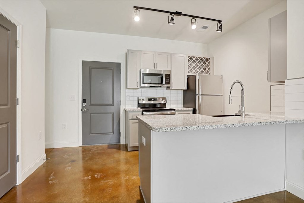 a kitchen with a counter top and a refrigerator