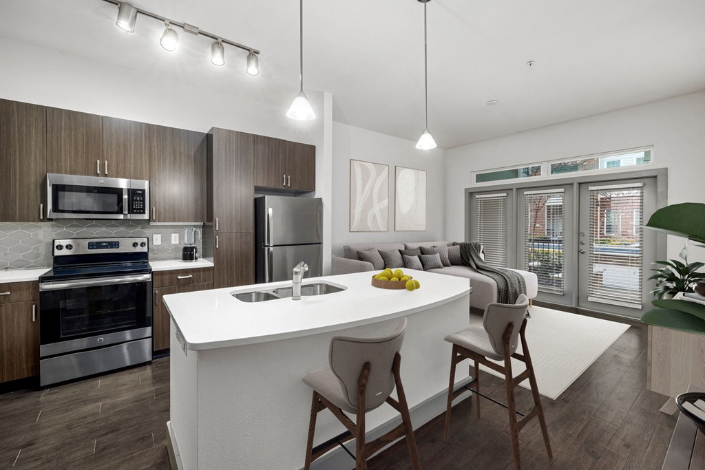 a kitchen and living room with a white counter top
