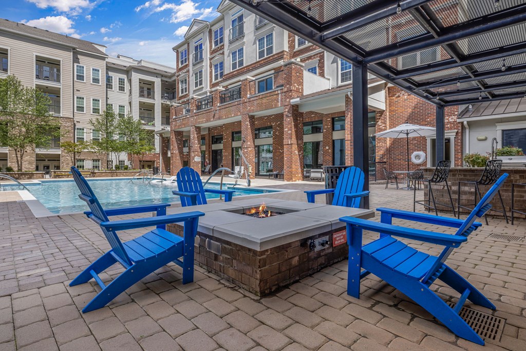 fire pit and chairs near the pool