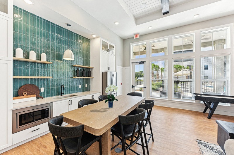 a dining room with a wooden table and chairs