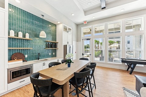 a dining room with a wooden table and chairs