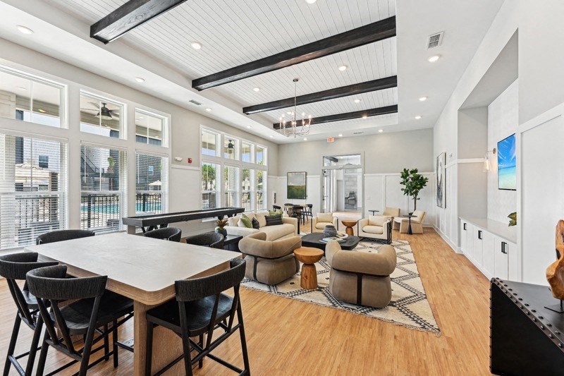 a large living room with a large table and chairs