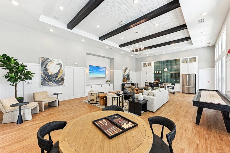 a large living room with a table and chairs