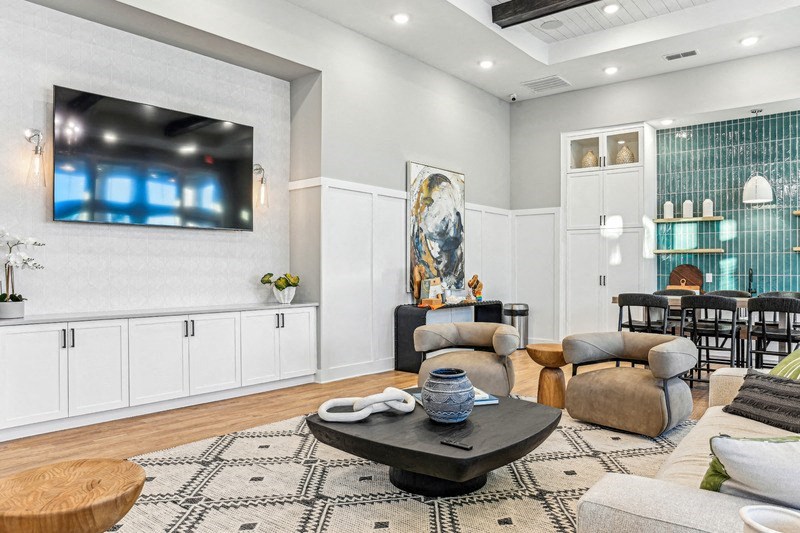 A modern living room with a flat screen TV mounted on the wall.