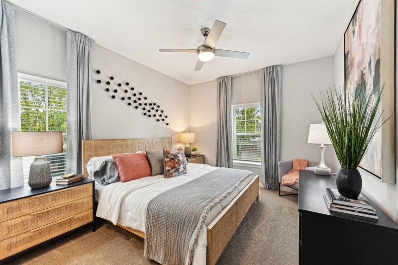 a bedroom with a large bed and a ceiling fan