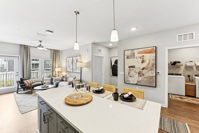 a kitchen with a center island and a living room
