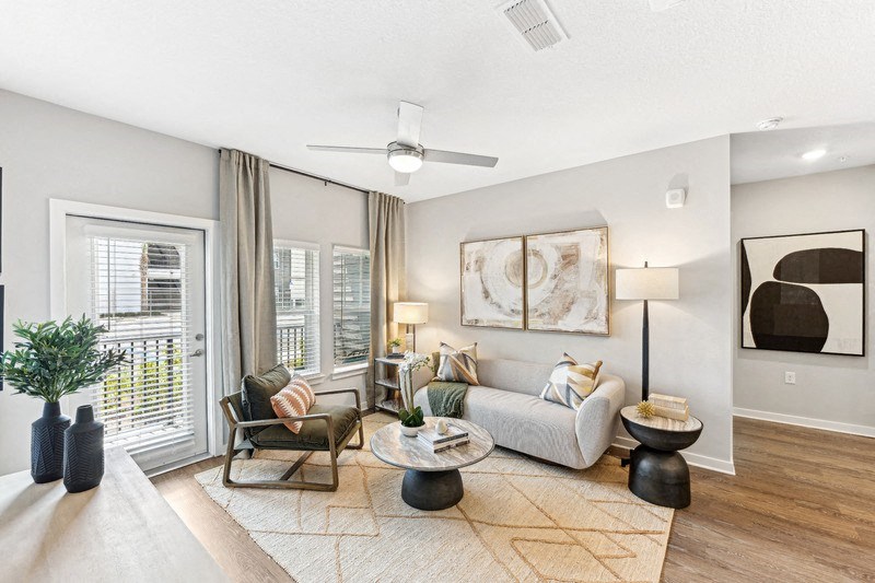 a living room with a couch and a ceiling fan