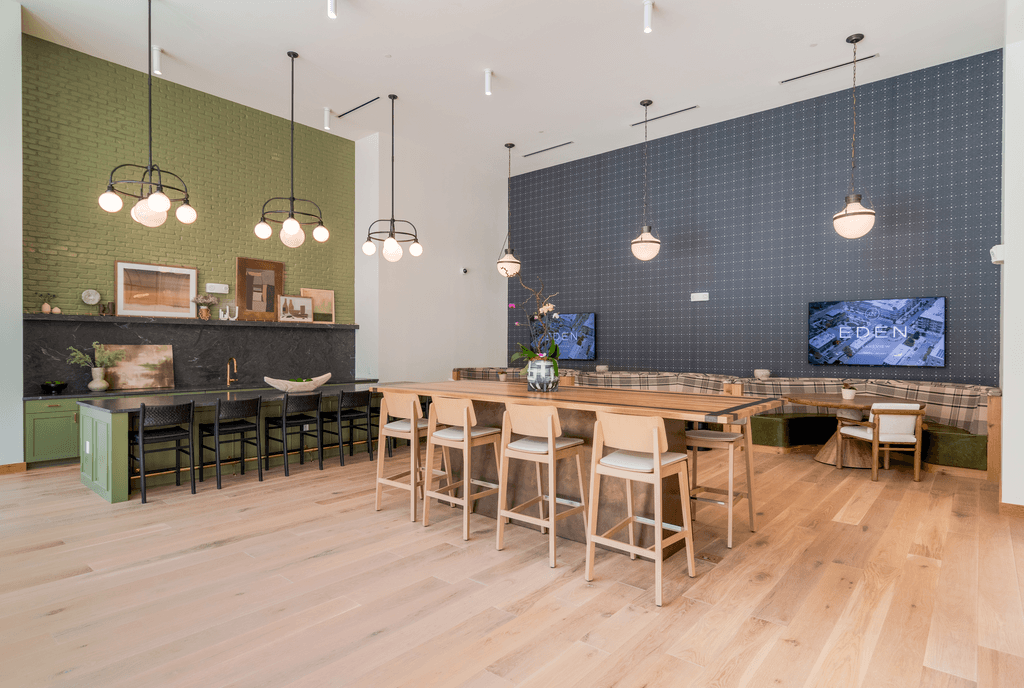 A modern dining room with a long wooden table and chairs.