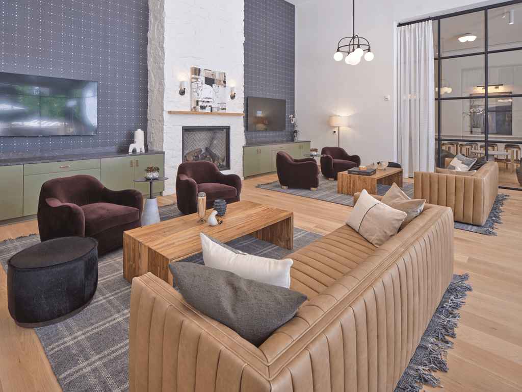 A living room with a fireplace and a large screen TV.