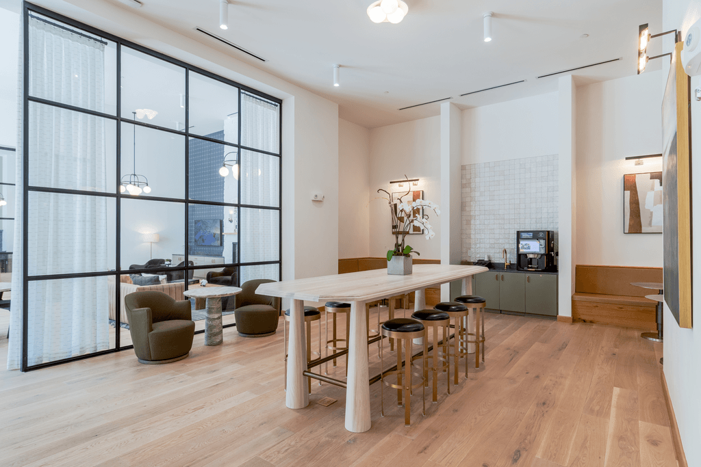 A modern dining room with a wooden table and chairs.