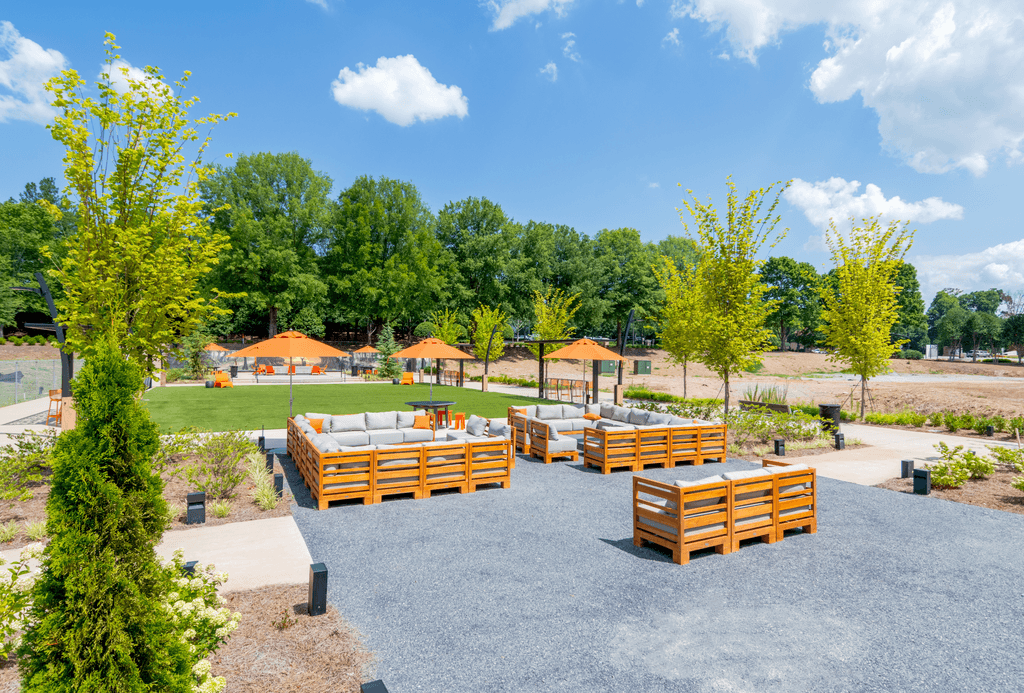A park with benches and trees.