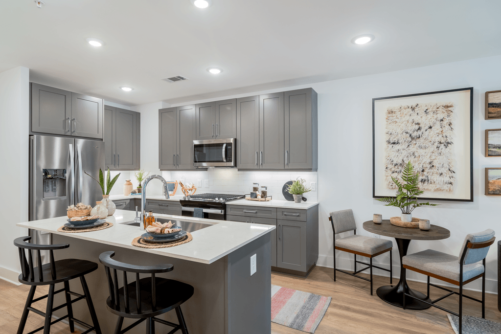 A modern kitchen with a dining table and chairs.