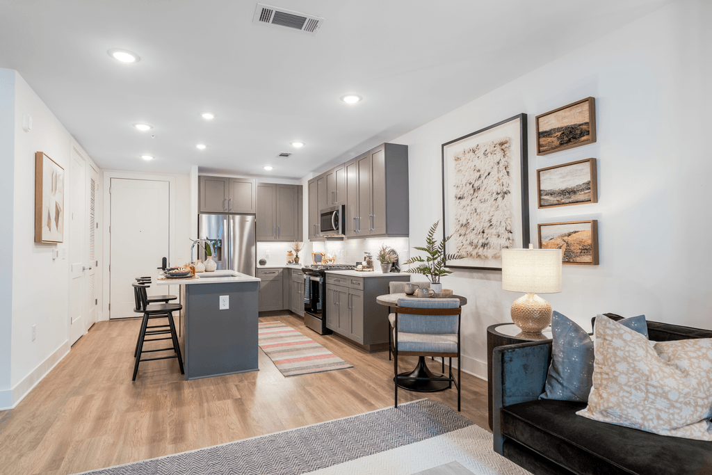 A modern kitchen with a dining table and chairs.