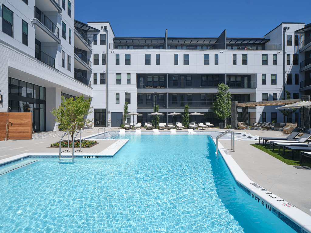 A large swimming pool in front of a modern building.
