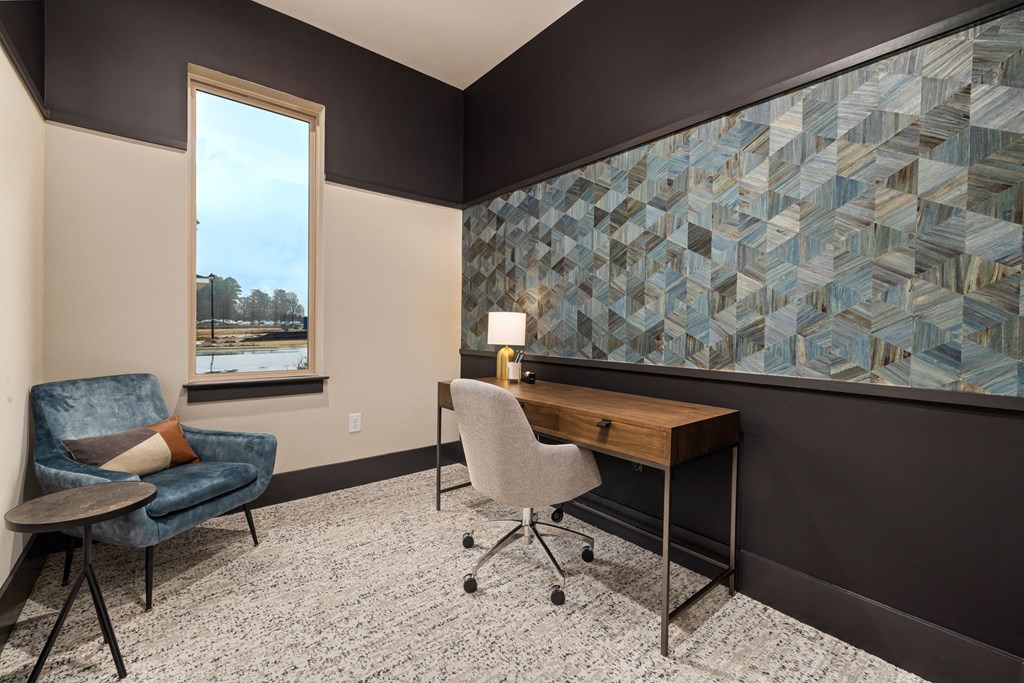 a home office with a desk and chair and a window