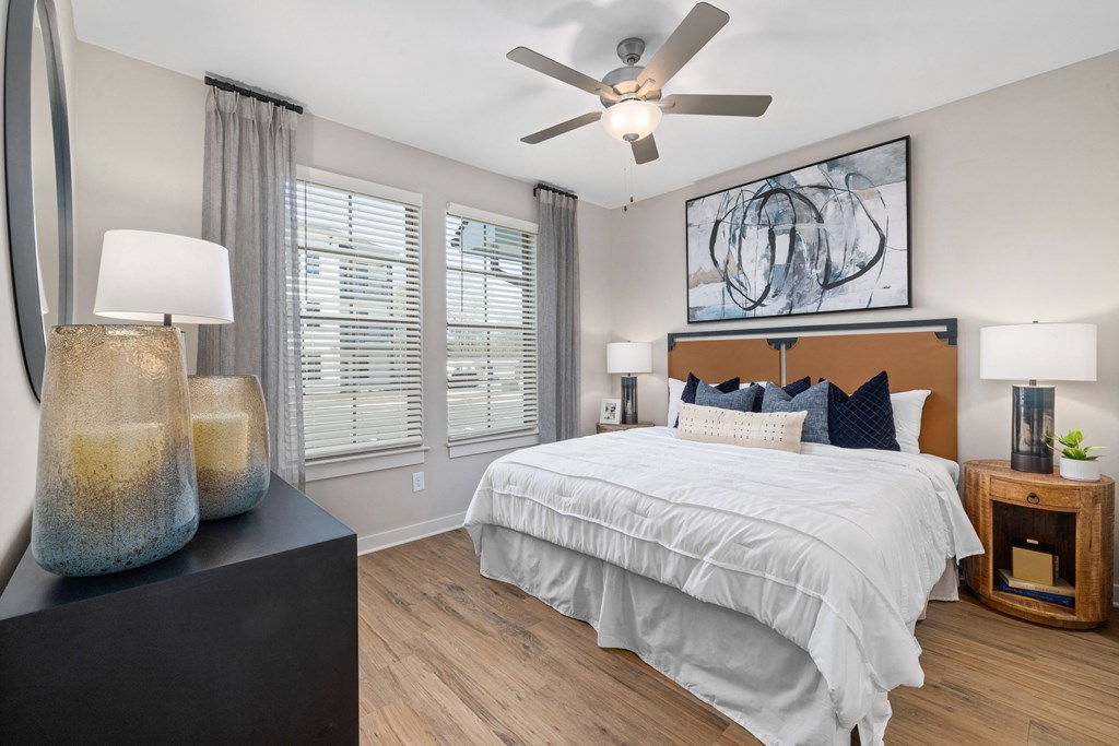 a bedroom with a large bed and a ceiling fan