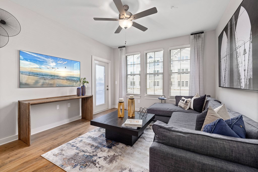 a living room with a couch and a ceiling fan
