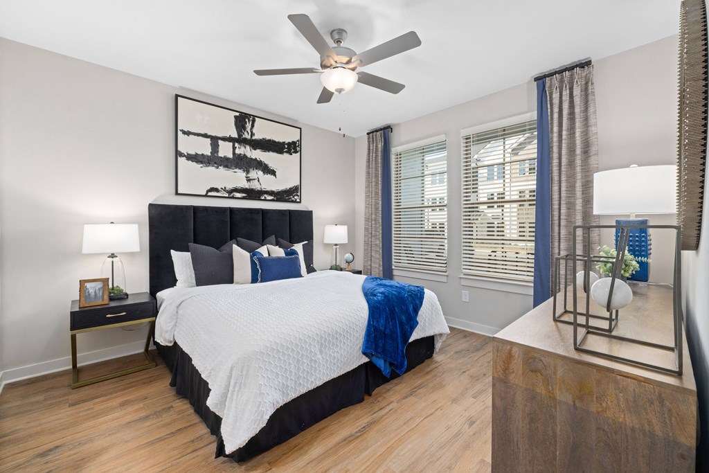 a bedroom with a large bed and a ceiling fan