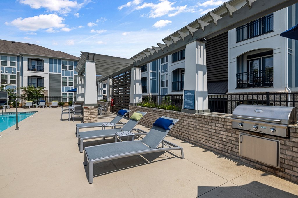 Long pool chairs and grill