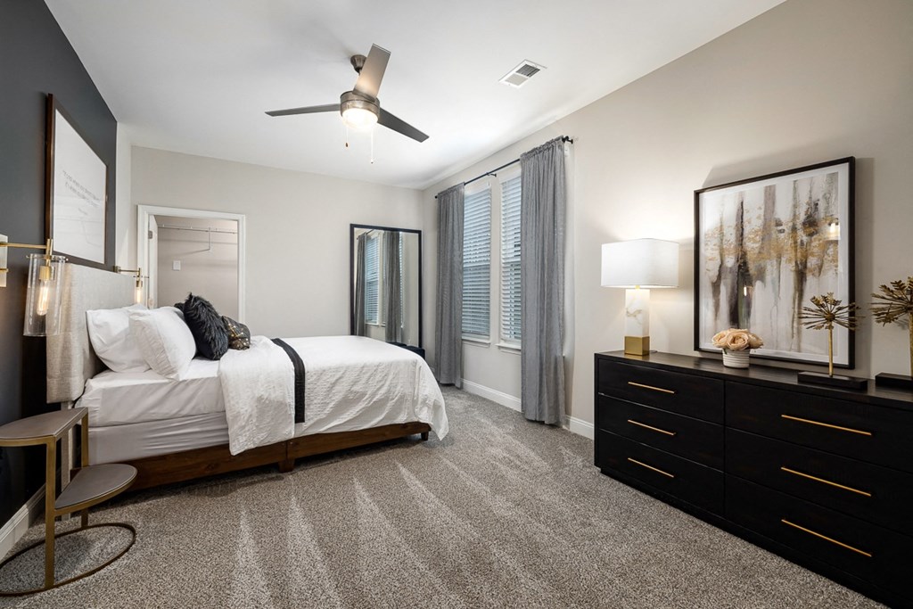 interior model bedroom with a large bed and a ceiling fan