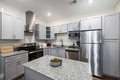 a kitchen with stainless steel appliances and granite counter tops