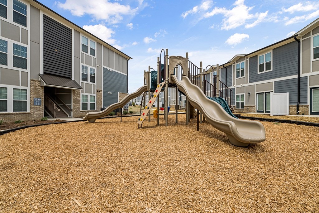 exterior playground with a slide and swings