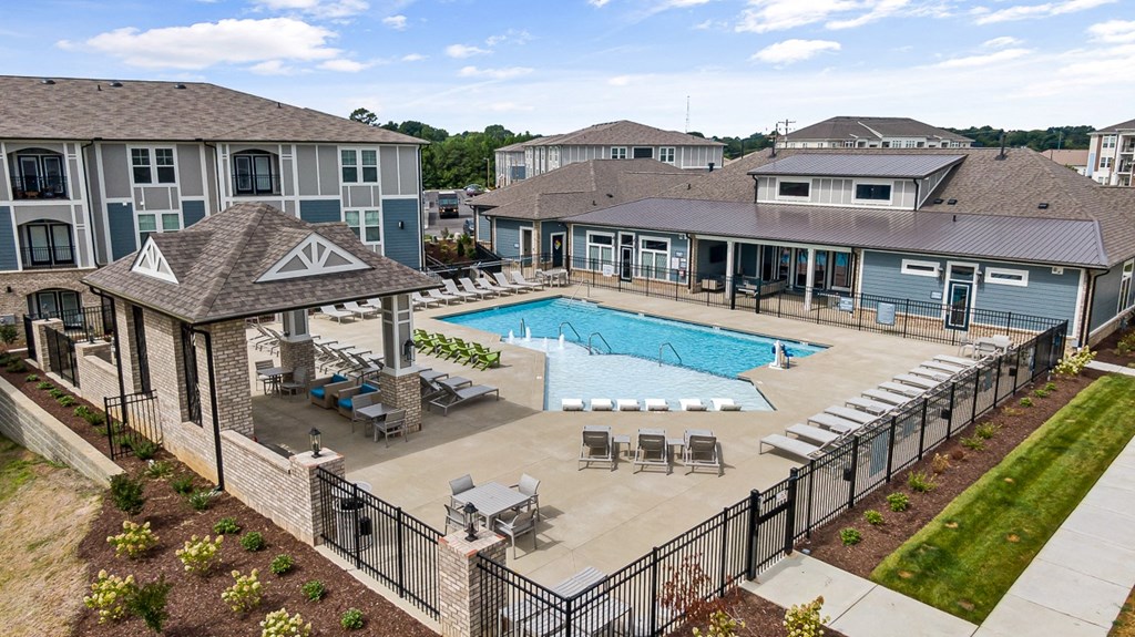an aerial view of exterior swimming pool with tables and chairs