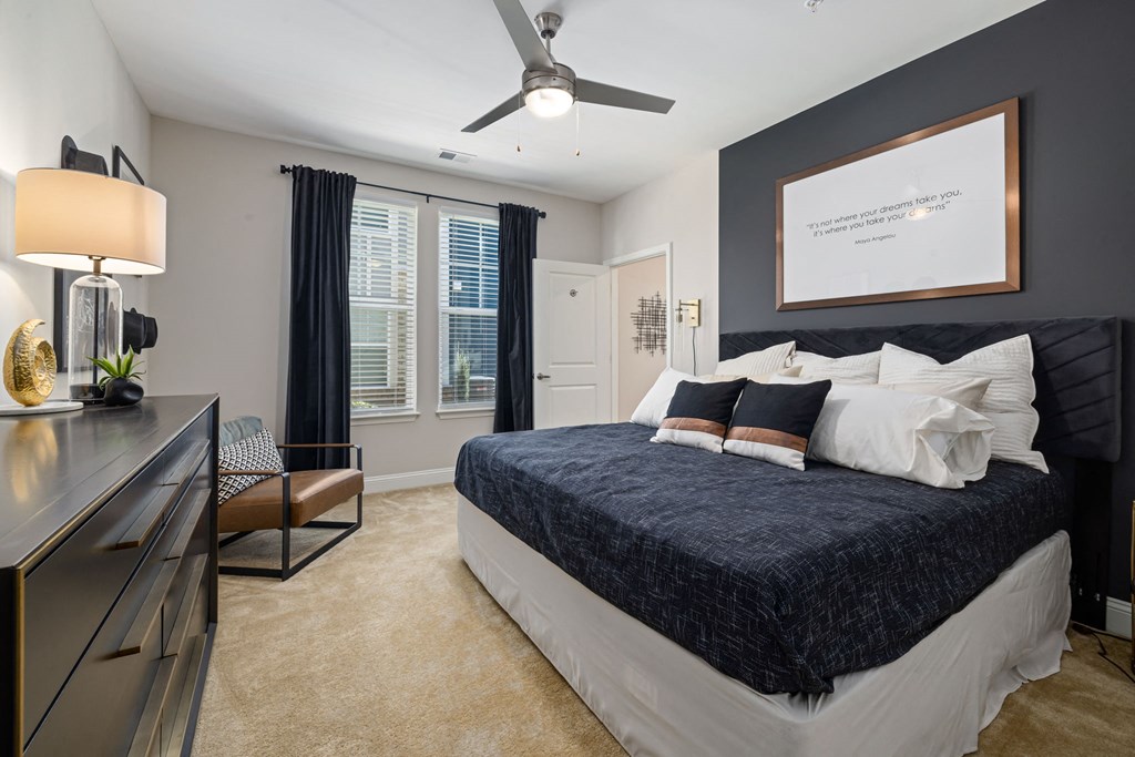 a bedroom with a bed and a ceiling fan