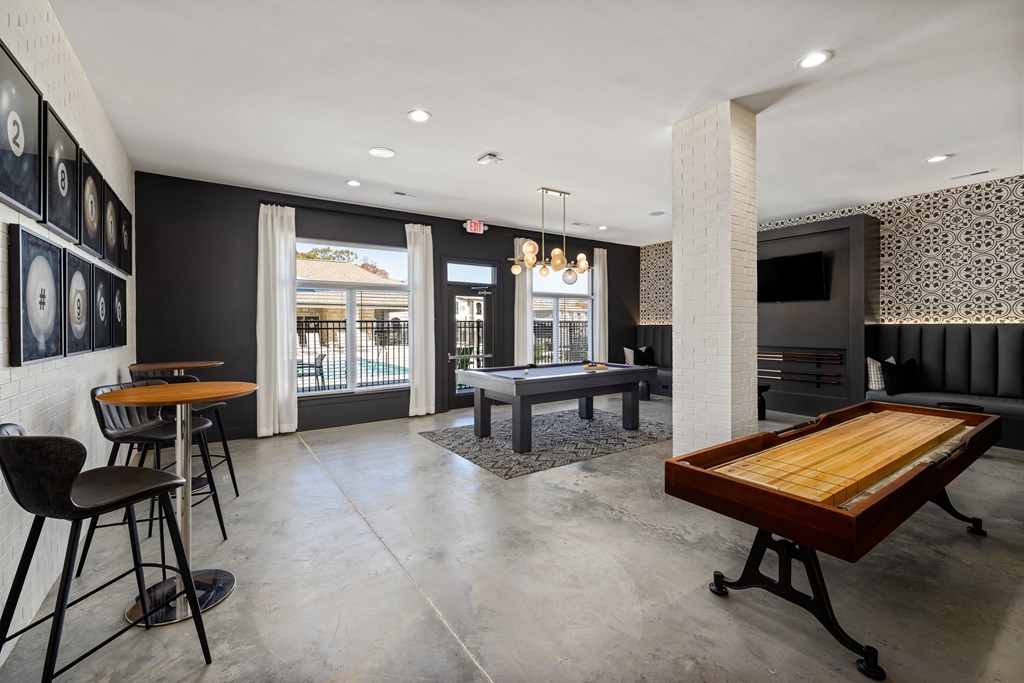 a game room with a pool table and a bar