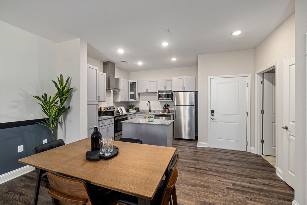 a kitchen and dining room with a table and chairs