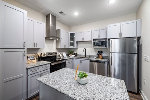 a kitchen with stainless steel appliances and granite counter tops