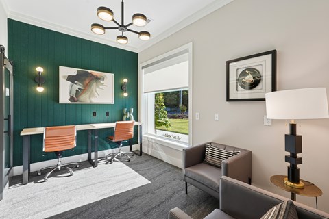 A room with a green wall and a window overlooking a green field.