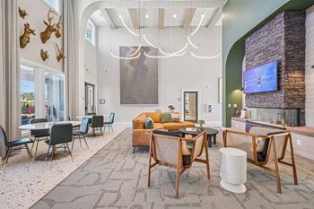 A modern living room with a stone fireplace and a flat screen TV.
