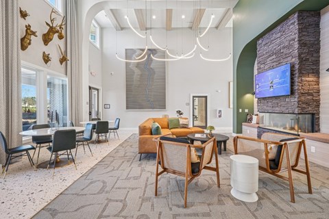 A modern living room with a stone fireplace and a television.