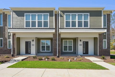 A modern two-story house with a grey and white exterior.