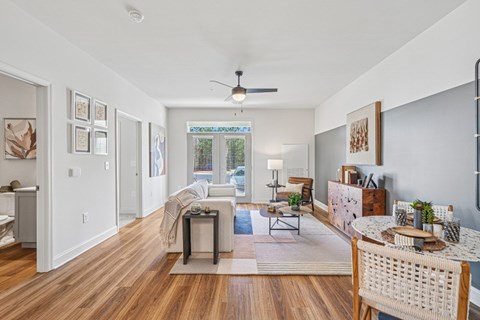 A living room with a white ceiling and a fan.