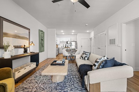 A modern living room with a white sofa and a coffee table.
