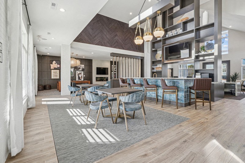 A modern dining room with a large table and chairs.