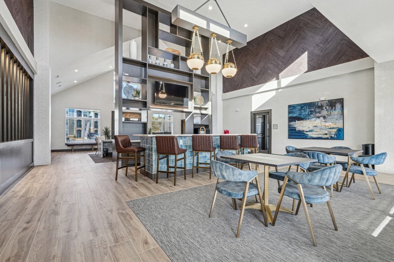 A modern dining room with a long table and chairs.