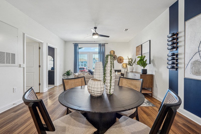 A dining room with a round table and chairs.