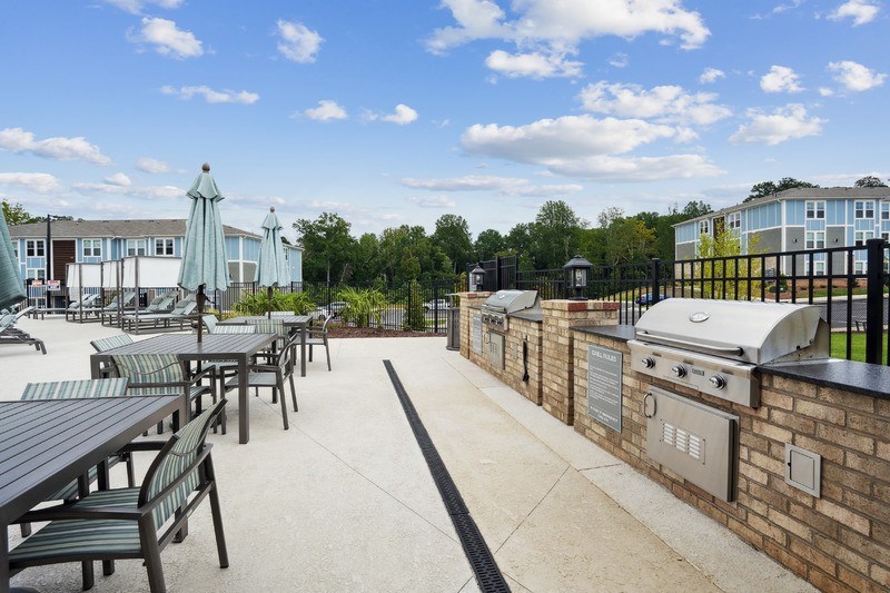 A sunny day at the outdoor dining area with tables and chairs.