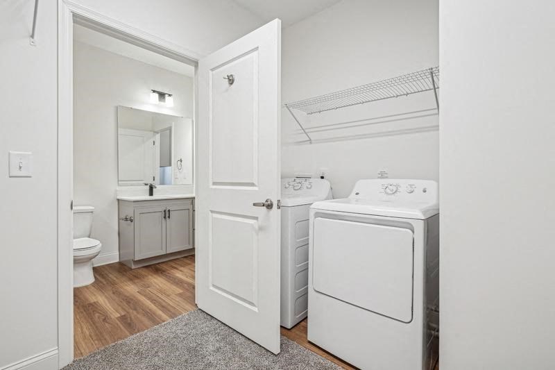 A white laundry room with a washer and dryer.