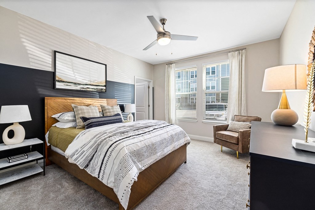 a bedroom with a bed and a ceiling fan