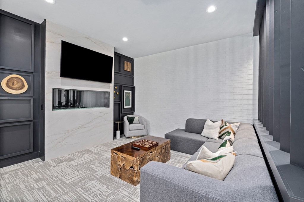a living room with a gray couch and a television