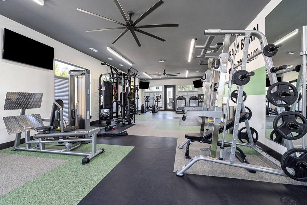a gym with weights and cardio equipment at the flats
