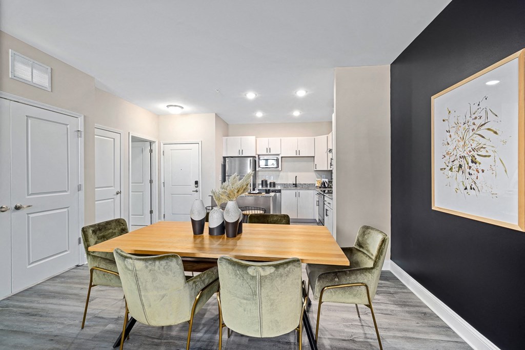 a dining room with a table and chairs and a kitchen