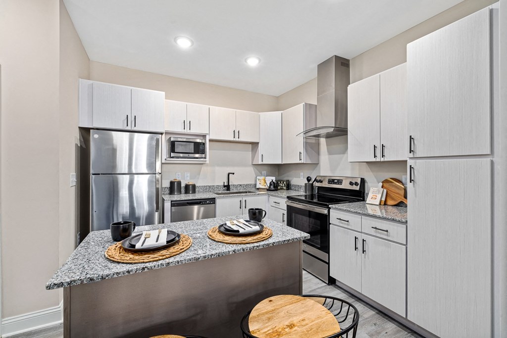 a kitchen with stainless steel appliances and white cabinets