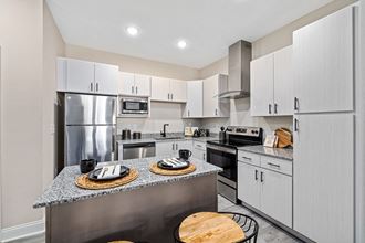 a modern kitchen with stainless steel appliances and granite counter tops