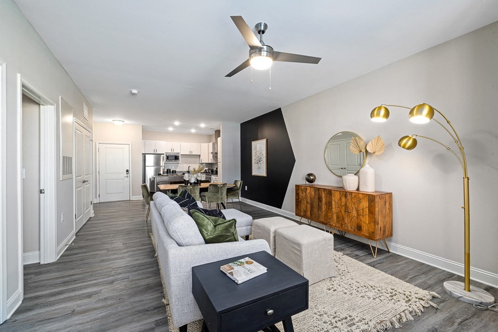 a living room with a white couch and a ceiling fan