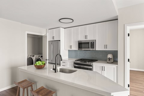 A kitchen with a blue back splash and new appliances
